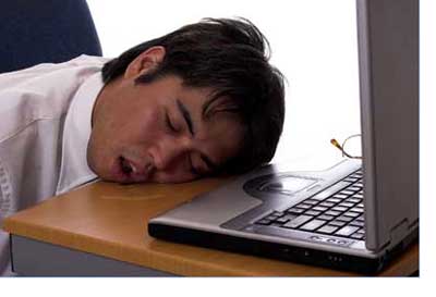 man asleep at the computer Dreamstime.com