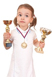 girl with a gold medal and cups.