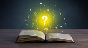 question-marks-over-book-yellow-hovering-open-81511615